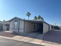 Manufactured home featuring covered parking at 9302 E Broadway Rd # 129, Mesa, AZ 85208