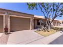 View of a single-story home with a desert landscape, two car garage and a covered entry at 1021 S Greenfield Rd # 1211, Mesa, AZ 85206