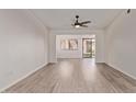 Spacious and well-lit living room with wood-look floors and access to the outdoor patio at 1021 S Greenfield Rd # 1211, Mesa, AZ 85206