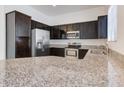 Gourmet kitchen featuring granite countertops, stainless steel appliances and dark wood cabinetry at 1367 S Country Club S Dr # 1125, Mesa, AZ 85210