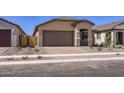 Inviting single-story home with a paved driveway and well-maintained desert landscaping at 15600 W Williams St, Goodyear, AZ 85338
