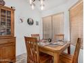 Cozy dining area with a wooden table, chairs, and natural light from the window at 16091 W Moreland St, Goodyear, AZ 85338