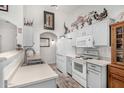 Functional kitchen with white appliances, ample cabinet space, and tile flooring at 16091 W Moreland St, Goodyear, AZ 85338