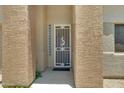 Inviting front entryway with security door and textured columns at 16450 E Avenue Of The Fountain -- # 20, Fountain Hills, AZ 85268