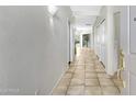 Bright hallway featuring neutral tile flooring and multiple closet doors at 16450 E Avenue Of The Fountain -- # 20, Fountain Hills, AZ 85268