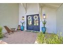 Inviting front entrance with double doors, brick pathway, potted cacti, and overhead lighting at 1712 E Fairfield St, Mesa, AZ 85203