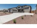 Beautiful two-story home featuring a three car garage, and a long concrete driveway at 17322 W Puget Ave, Waddell, AZ 85355