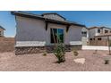 Side view of charming two-story home featuring desert landscaping and a stone-accented facade at 17322 W Puget Ave, Waddell, AZ 85355