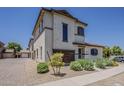 Charming two-story home has desert landscaping and an open parking area at 2540 N 148Th Dr, Goodyear, AZ 85395