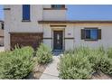 Inviting front entrance of a two-story home, framed by desert landscaping at 2540 N 148Th Dr, Goodyear, AZ 85395