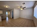 View of the living room with a ceiling fan and natural light at 2745 E Wood St, Phoenix, AZ 85040