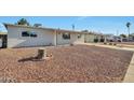 Exterior shot of the home showcasing the desert landscaping and covered porch at 2823 W Banff Ln, Phoenix, AZ 85053