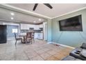 Open living space with tile floors, neutral walls, and a ceiling fan flowing into dining area at 2823 W Banff Ln, Phoenix, AZ 85053