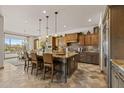 Open kitchen with large island, breakfast bar, and custom cabinets at 3119 E Bellflower Dr, Gilbert, AZ 85298