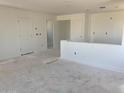 An unfinished living room displaying its spacious layout and bright, neutral walls at 32016 N Pony Express Rd, San Tan Valley, AZ 85143