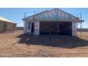 Home under construction, showcasing the framing, and garage with scaffolding in place at 32254 N Pony Express Rd, San Tan Valley, AZ 85143