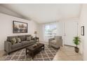 Inviting living room features neutral tones, a comfortable seating arrangement, and ample natural light at 3408 N 69Th Dr, Phoenix, AZ 85033