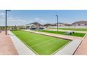 Birdsong Park featuring bocce ball court, cornhole, and picnic tables under a shaded structure at 36550 W Maddaloni Ave, Maricopa, AZ 85138