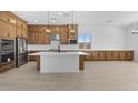 Spacious kitchen with stainless steel appliances, a large island, and stylish pendant lighting at 37695 W Santa Maria St, Maricopa, AZ 85138