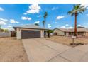 A charming single-story home with a wide driveway, showcasing a well-kept exterior and a two-car garage at 4226 W Evans Dr, Phoenix, AZ 85053