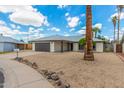 A lovely single-story home, featuring a wide driveway, with a two-car garage and xeriscaped front yard at 4226 W Evans Dr, Phoenix, AZ 85053