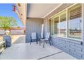 Cozy front porch with brick accents, comfortable seating, and a view of the neighborhood at 4363 E Dragoon Cir, Mesa, AZ 85206