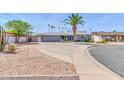 Inviting single-story home with desert landscaping and a spacious driveway, perfect for families at 4363 E Dragoon Cir, Mesa, AZ 85206