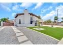 Beautiful home features a well-maintained front yard, a charming walkway, and an inviting entrance at 4601 E Carolina Dr, Phoenix, AZ 85032