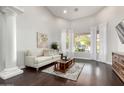 Bright living room with high ceilings, decorative pillars, hardwood floors, and a view of the backyard at 4618 W Pokeberry Ln, Phoenix, AZ 85083