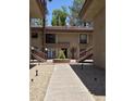 Exterior view of a well-maintained condo building with desert landscaping and stairs at 5035 N 10Th Pl # 109, Phoenix, AZ 85014