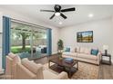 Cozy living room with a comfortable seating area, modern fan, and natural light at 556 S Forest --, Mesa, AZ 85204