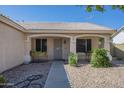 Inviting front porch featuring decorative plants, a security door, and desert landscaping at 7930 W Colter St, Glendale, AZ 85303