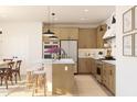 Bright kitchen with a large island, stainless steel appliances, and modern pendant lights at 8041 W Griswold Rd, Peoria, AZ 85345