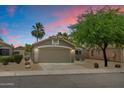 Charming single-story home featuring a neutral color palette, desert landscaping, and a two-car garage at 810 E Potter Dr, Phoenix, AZ 85024