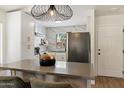 Eat-in kitchen with white cabinets, stainless steel appliances, and a modern island with bar seating at 810 E Potter Dr, Phoenix, AZ 85024