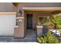 Close-up of front porch details with a wrought iron security door and desert landscaping at 838 W Basswood Ave, Queen Creek, AZ 85140