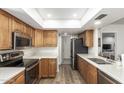 Spacious kitchen with stainless steel appliances, wood cabinets, and modern countertops at 903 W Shawnee Dr, Chandler, AZ 85225