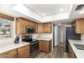 Well-lit kitchen with stainless steel appliances, wood cabinets, and white countertops at 903 W Shawnee Dr, Chandler, AZ 85225