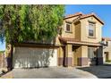 Two story home with a two-car garage, desert landscaping, and a tiled roof at 9415 W Eaton Rd, Phoenix, AZ 85037