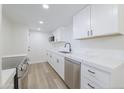 Bright kitchen featuring white cabinets, stainless steel appliances, and quartz countertops at 948 S Alma School Rd # 1, Mesa, AZ 85210