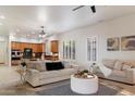 Bright living room featuring neutral tones, plush seating, and a seamless flow to the kitchen for modern living at 11193 N 121St Way, Scottsdale, AZ 85259