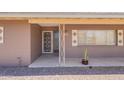 Inviting front porch features desert landscaping, vintage accents, and a sheltered entryway at 1124 S Longwood Loop, Mesa, AZ 85208