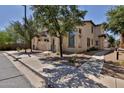 Inviting two-story townhome featuring neutral stucco, desert landscaping, and a sidewalk at 14870 W Encanto Blvd # 1038, Goodyear, AZ 85395