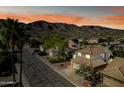 Charming street view featuring well-maintained homes and desert landscaping against a backdrop of scenic mountains at 15411 S 13Th Ave, Phoenix, AZ 85045