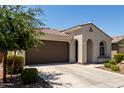 Beautiful single-story home with a two-car garage and desert-friendly landscaping at 19751 W Adams St, Buckeye, AZ 85326