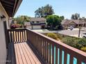 View from wood balcony overlooking neighborhood, lush greenery, and the property's private pool at 2050 W Nido Ave, Mesa, AZ 85202
