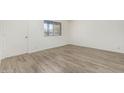 Bright bedroom with ample natural light, wood-look flooring, and a neutral color palette at 2117 W 2Nd St, Mesa, AZ 85201