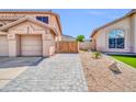 Private home featuring a paved walkway to the front gate and low-maintenance landscaping at 22019 N 59Th Dr, Glendale, AZ 85310