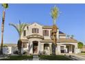 Charming two-story home featuring a terracotta tile roof, red shutters, and manicured front yard at 2501 S Roanoke St, Gilbert, AZ 85295
