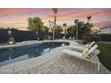 Relaxing backyard oasis with a sparkling pool, comfortable lounge chairs, and mature landscaping at 2501 S Roanoke St, Gilbert, AZ 85295